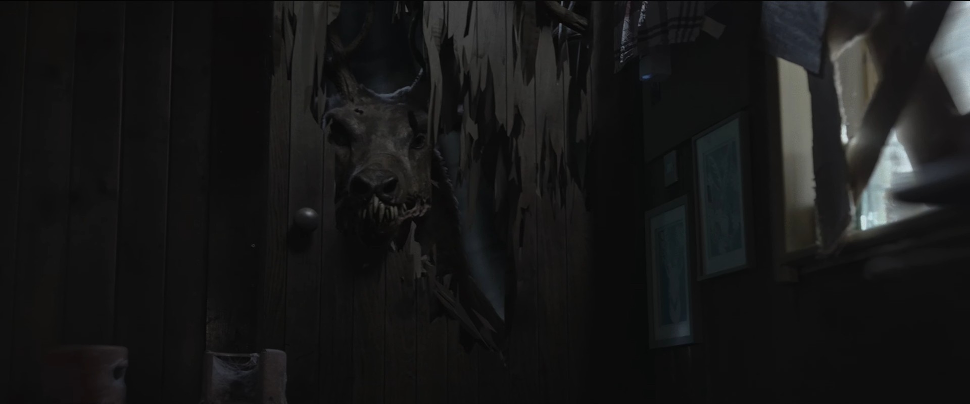 mutant reindeer with his head in broken door