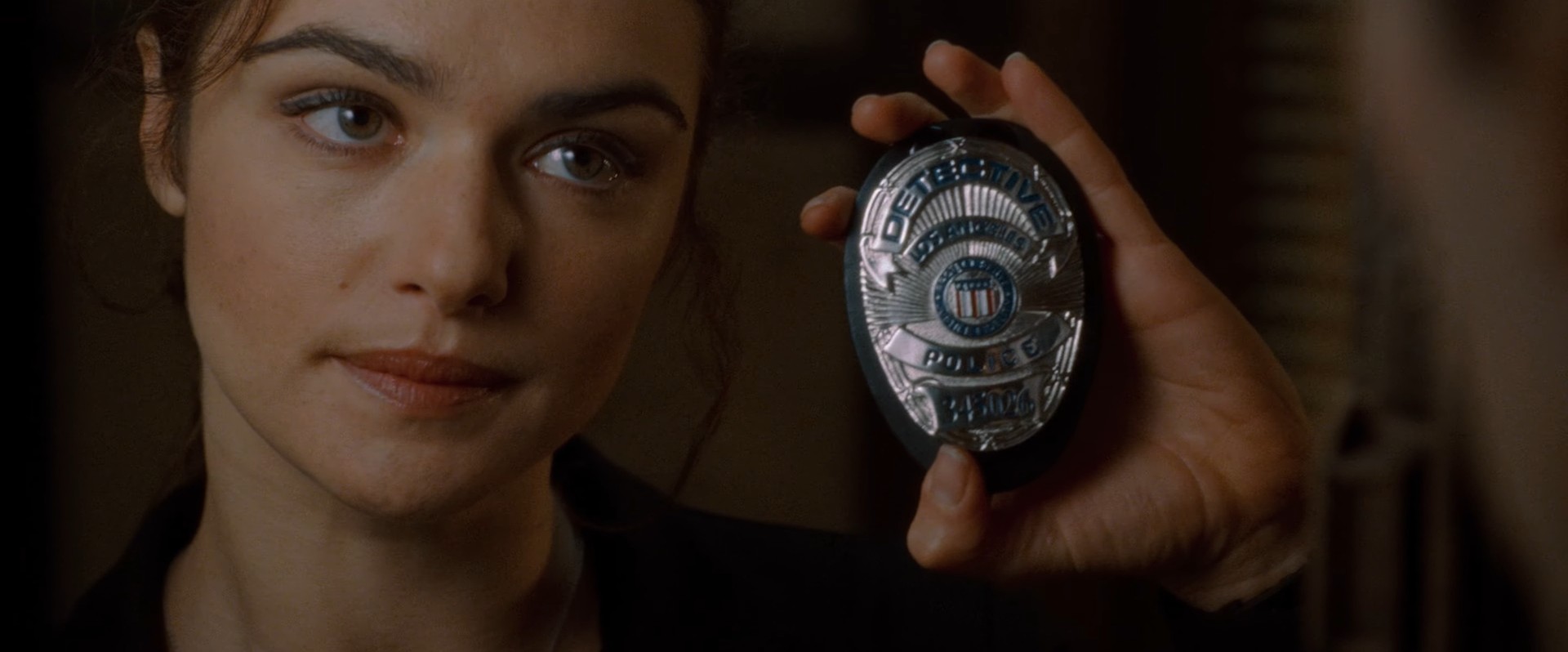 Isabel, a police woman, showing Constantine her badge
