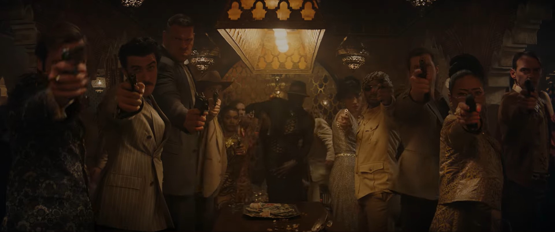 a mob and mix of different people aiming guns at Indiana Jones